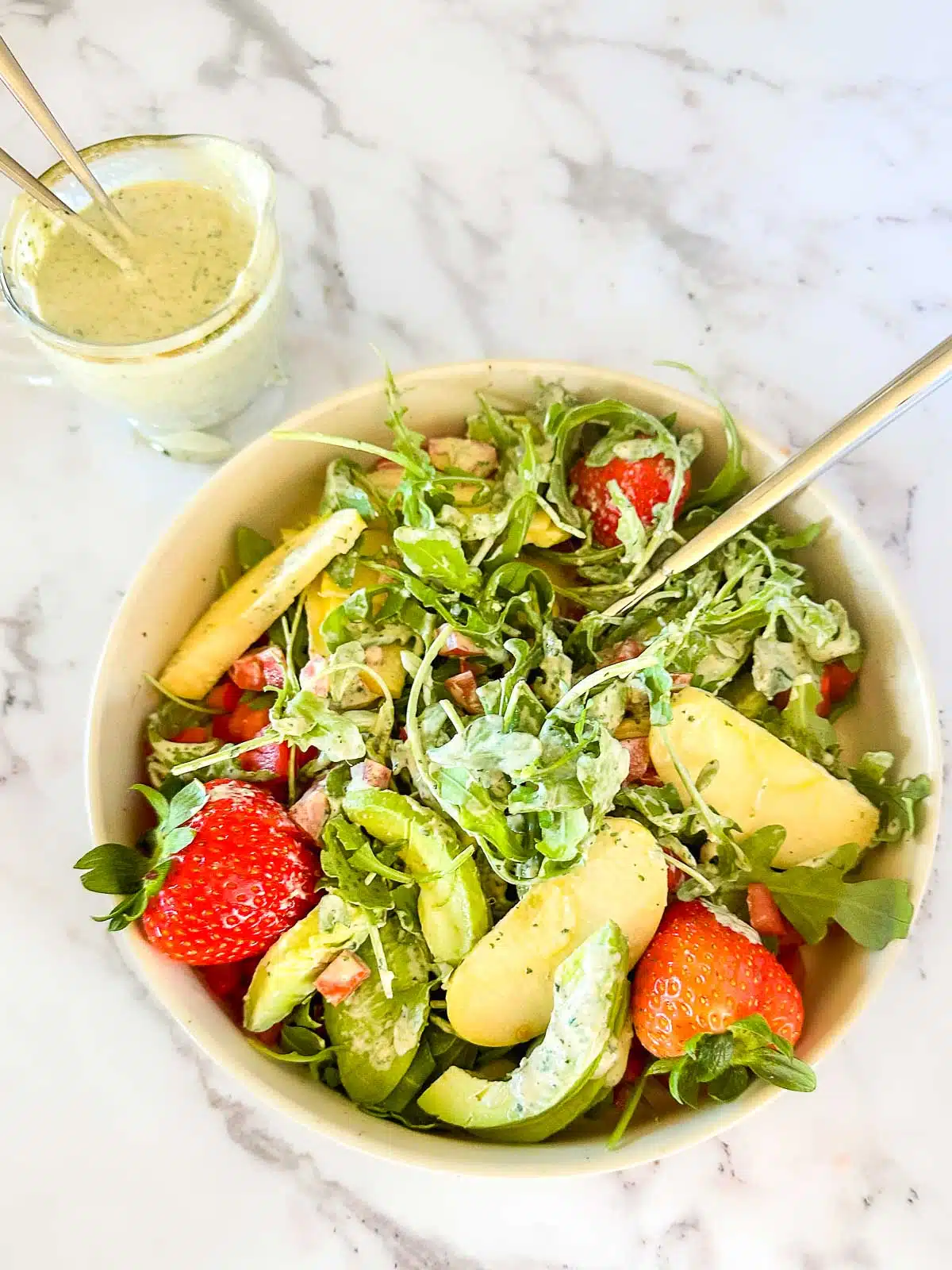 Lemon herb tahini tossed into a salad.