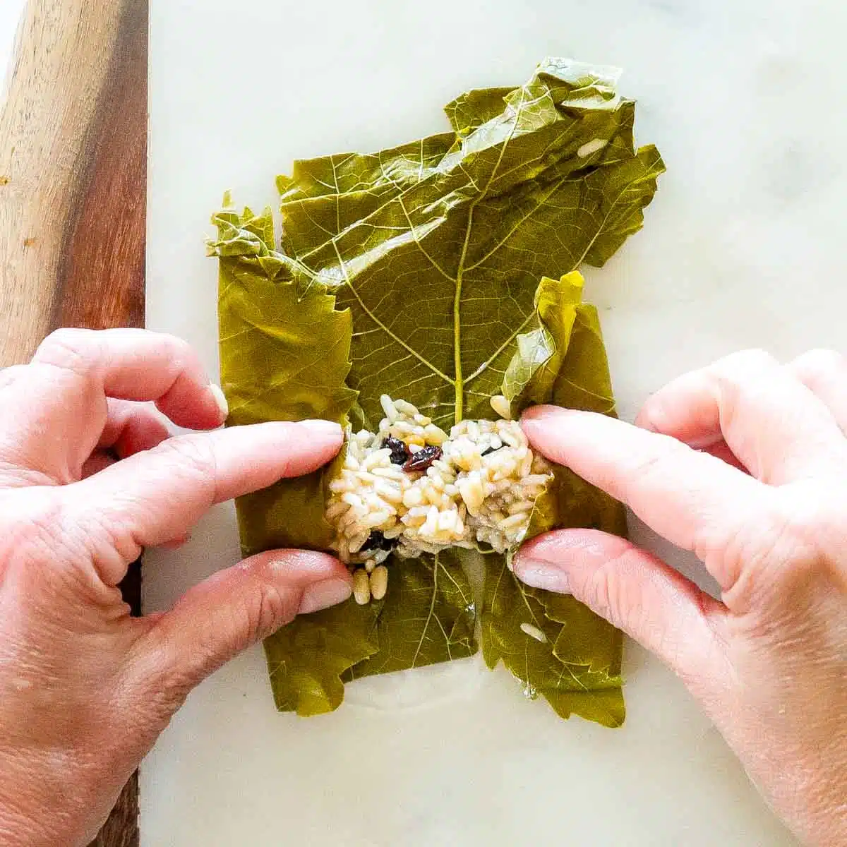 Sides of the grape leaf being tucked in. 