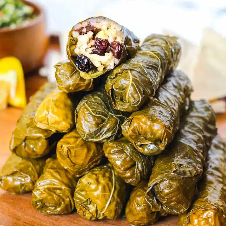 Pyramad of Turkish grape leaves with the top grape leaf showing the stuffing.