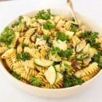 Creamy tahini pasta garnished with parsley.