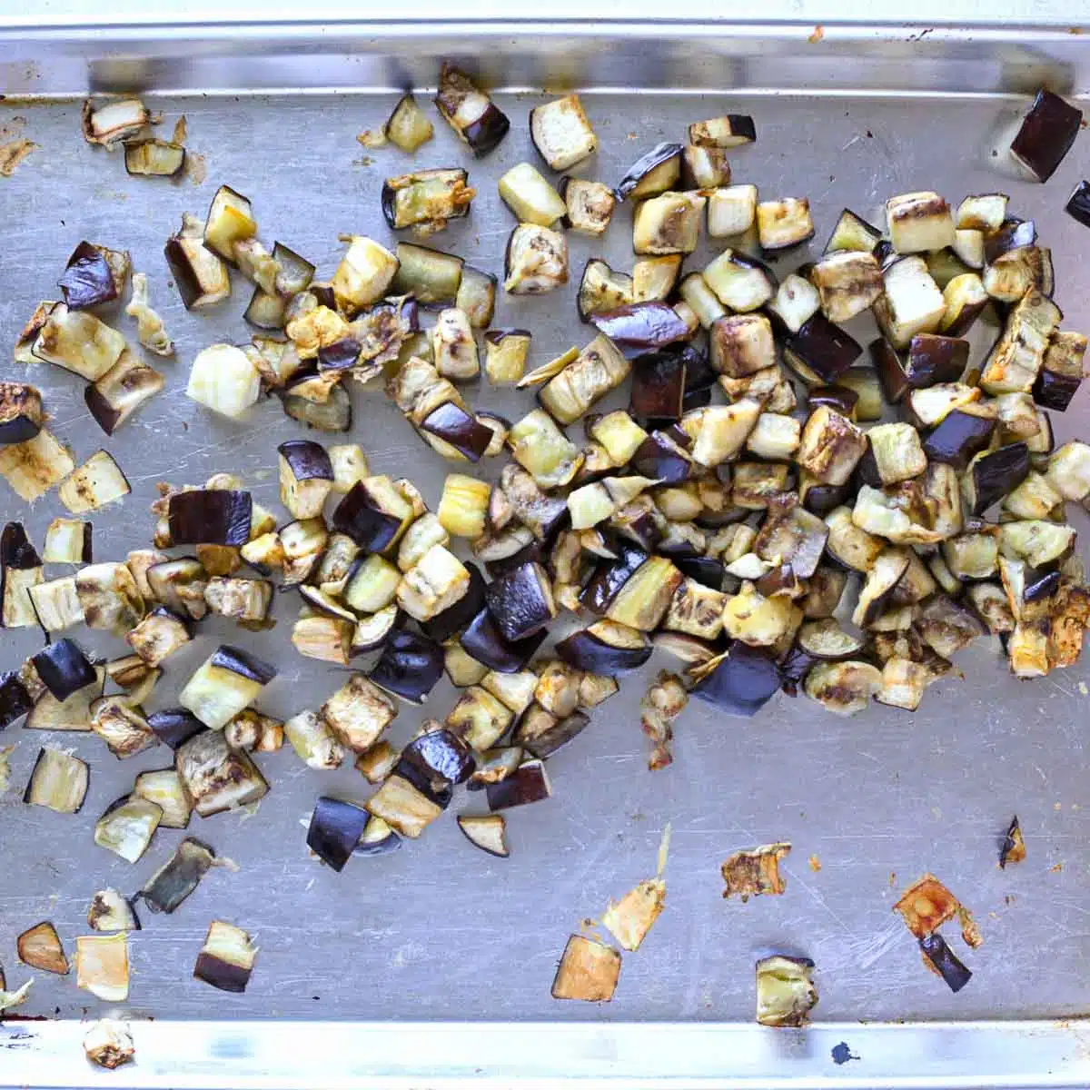 Roasted eggplant on a baking sheet.