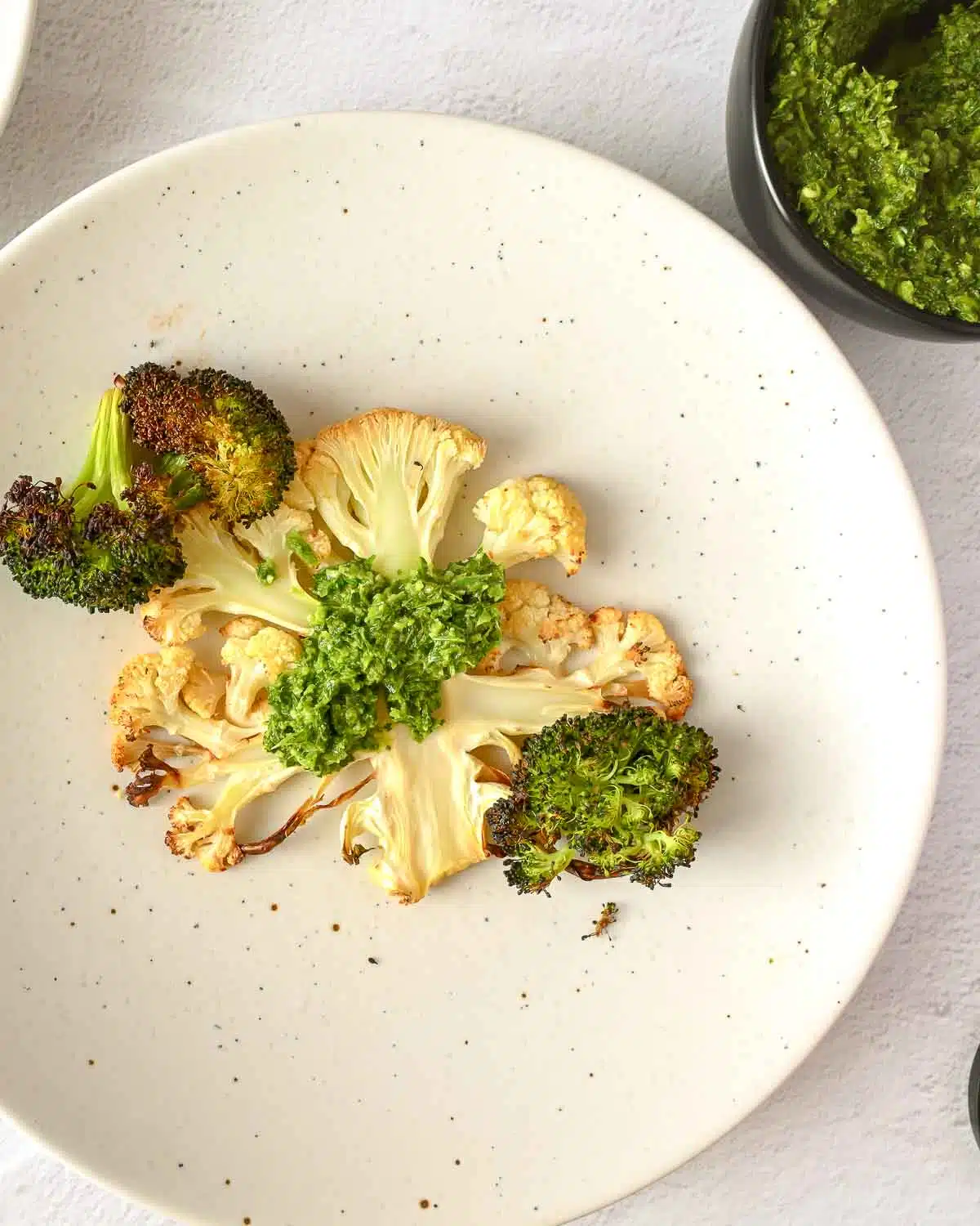Green harissa spooned on a cauliflower steak. 