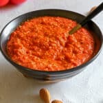 Red pepper pesto in a bowl with a spoon
