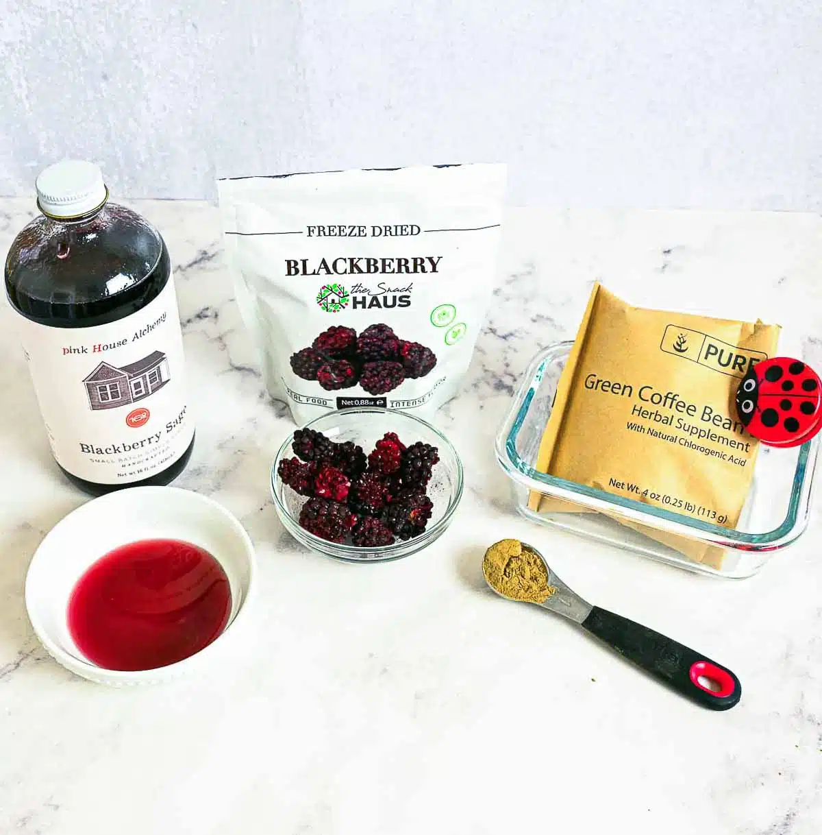 Ingredients used in making the recipe (Blackberry sage syrup, freeze-dried blackberries, and green coffee extract).
