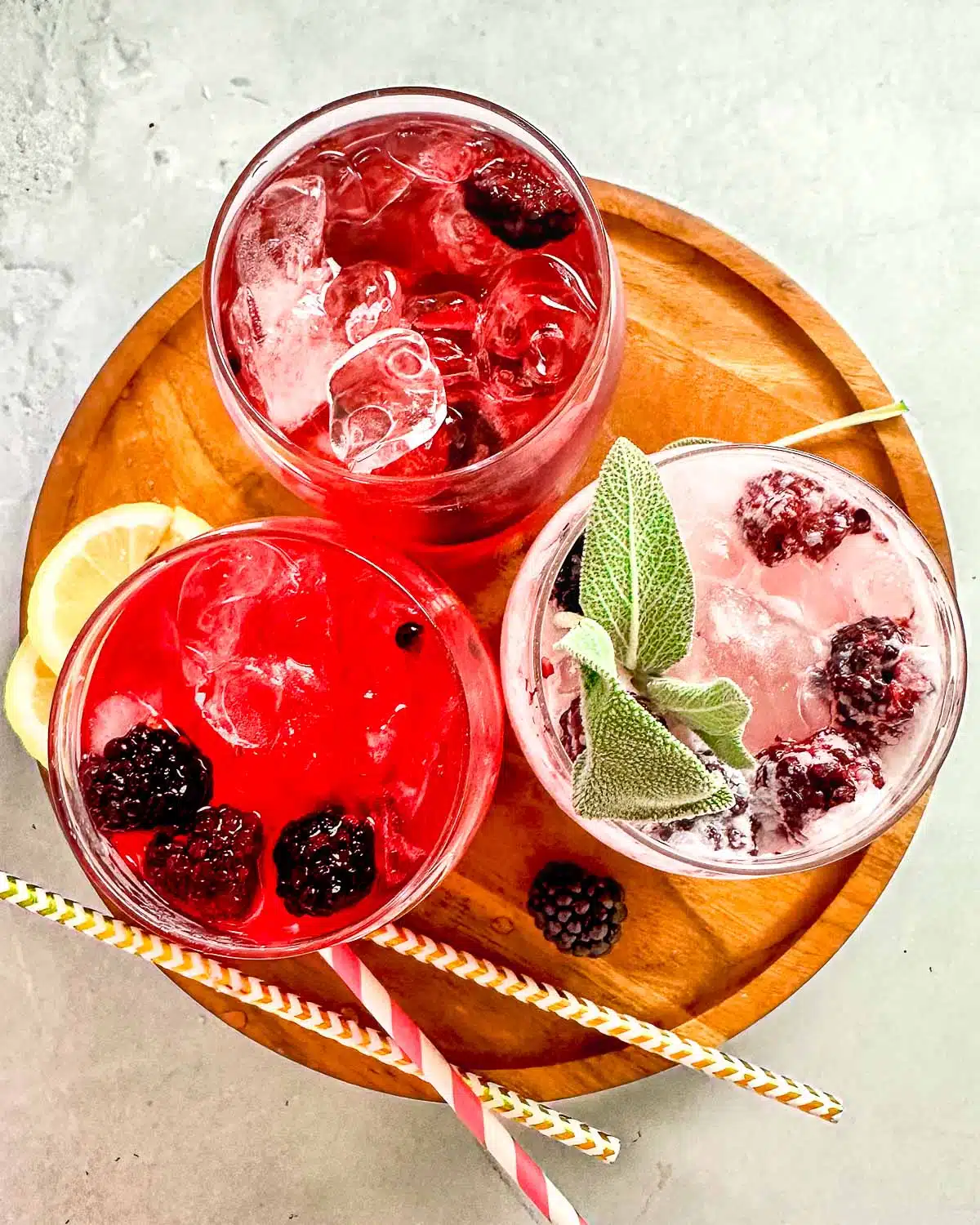 All three versions of the blackberry refreshers garnished and photographed from the top down. 
