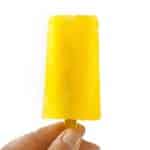 Hand holding up a lemonade popsicle.