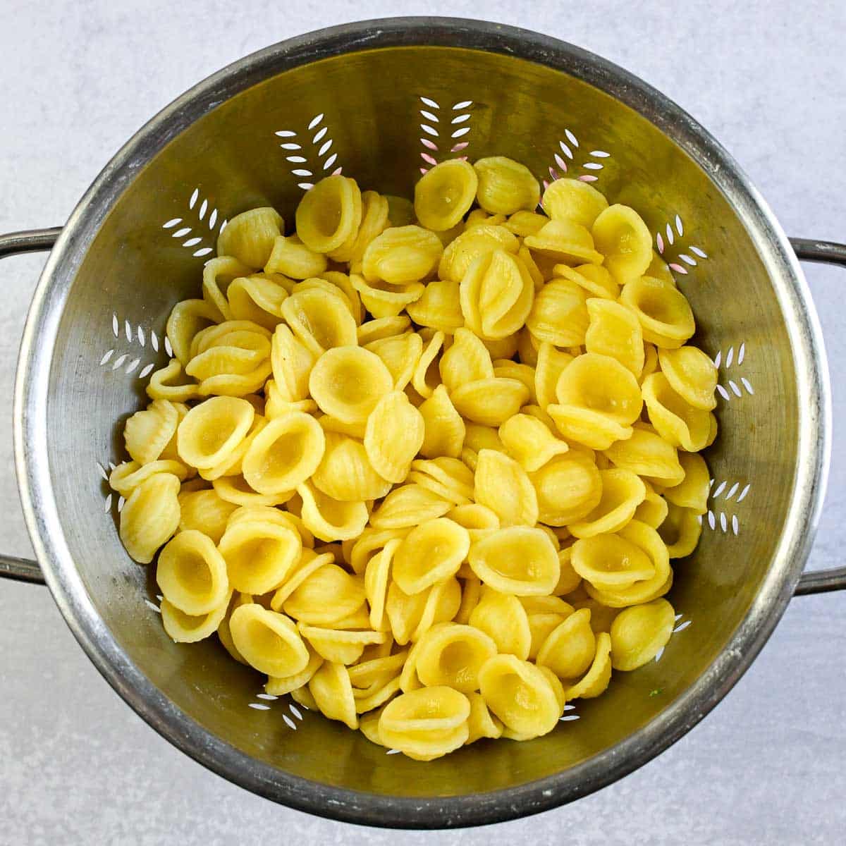 Pasta drained and rinsed in a colander.