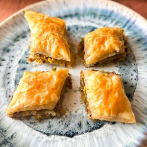 Four diamonds of baklava on a plate.