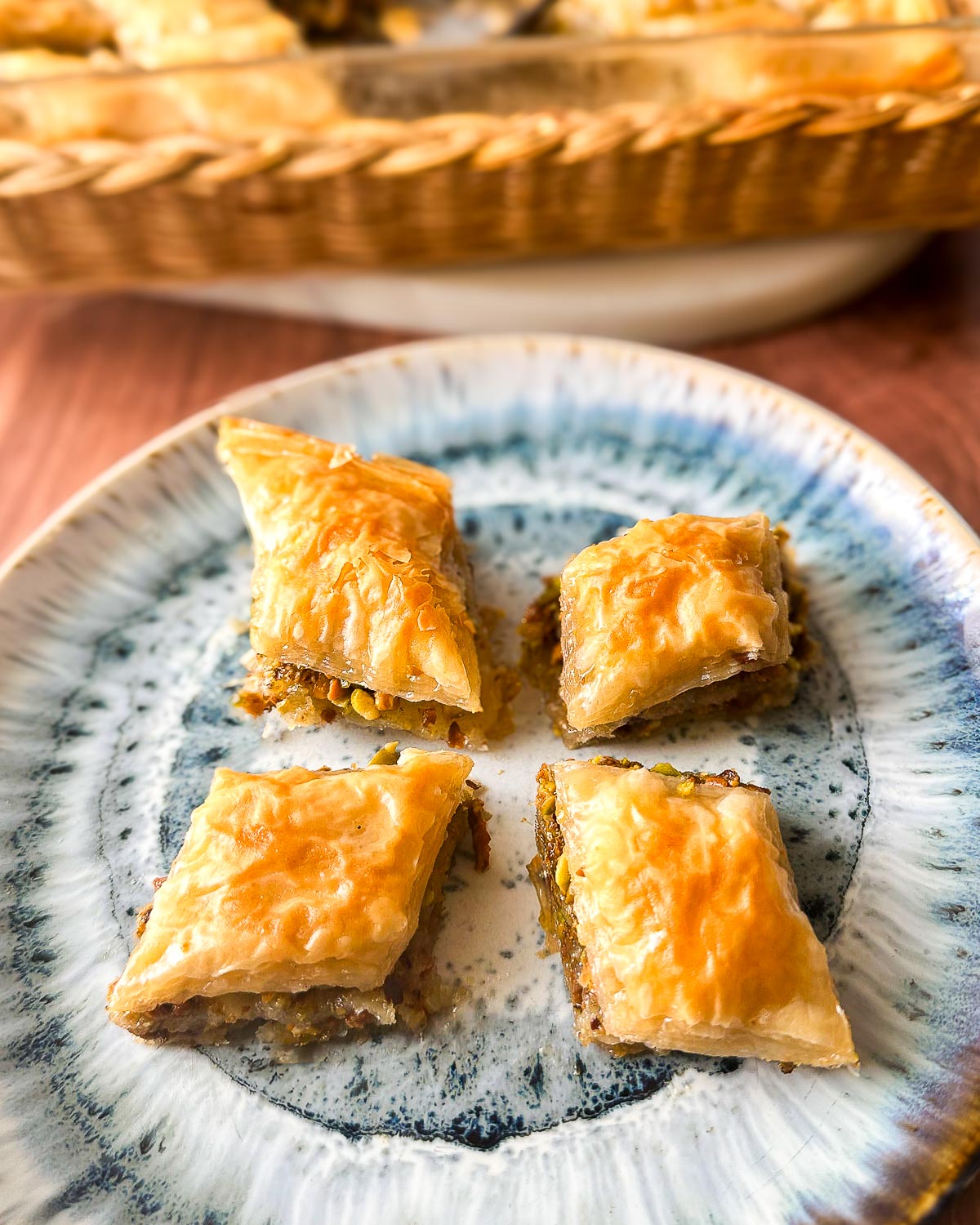 Four diamonds of baklava on a plate.