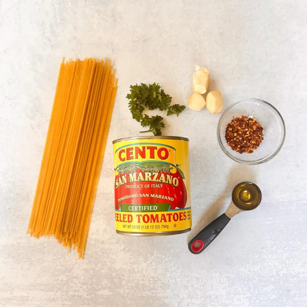Ingredients used in making Spaghetti All’Arrabbiata: pasta, San Marzano tomatoes, garlic, crushed red pepper, and parsley