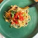 Spaghetti all’Arrabbiata served on a plate, garnished with fresh parsley.