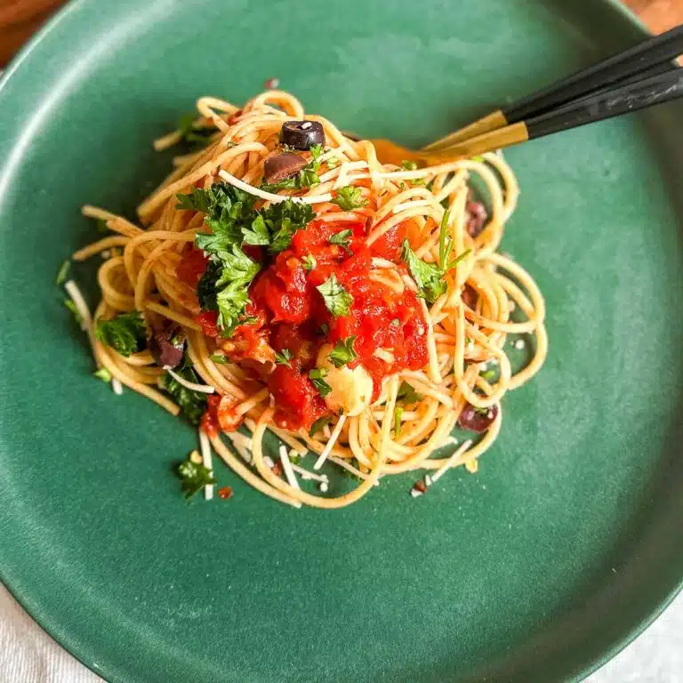 Spaghetti all’Arrabbiata served on a plate, garnished with fresh parsley.