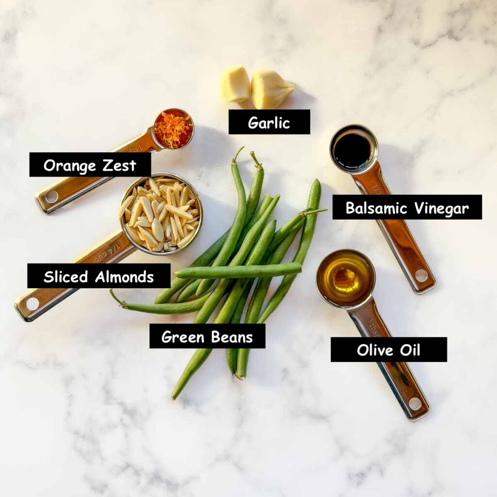 Ingredients used in making balsamic beans: green beans, olive oil, balsamic vinegar, garlic, sliced almonds and orange zest.