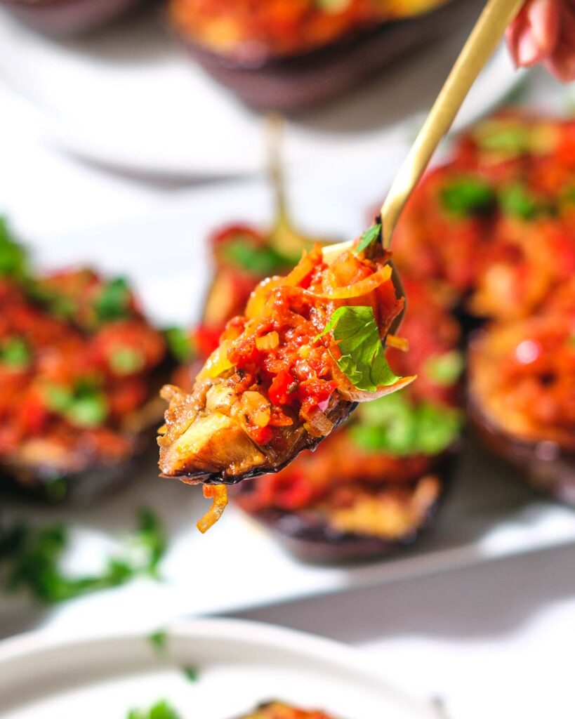 Ottoman Turkish eggplant being held up to the camera on a gold fork.