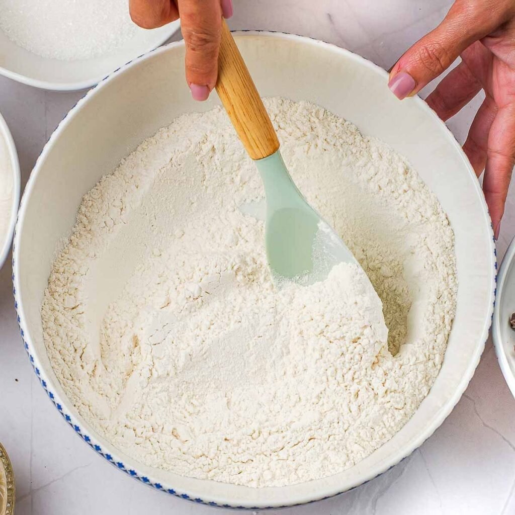 A bowl filled with dry ingredients to make cookie dough.