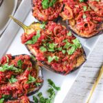 Imam Biladyi on a white plate garnished with flat Italian parsley.