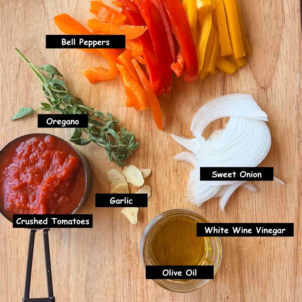 Ingredients used in making peperonata (bell pepper, oregano, sweet onions, crushed tomatoes, garlic, olive oil, and white wine vinegar)