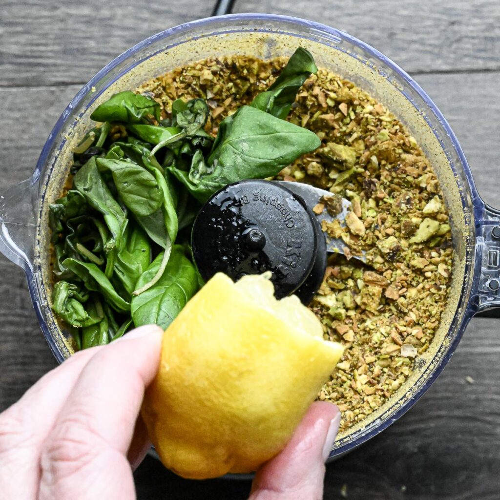 Pistachio pesto basil after first rough chop with basil and lemon in a food processor before being pulsed.