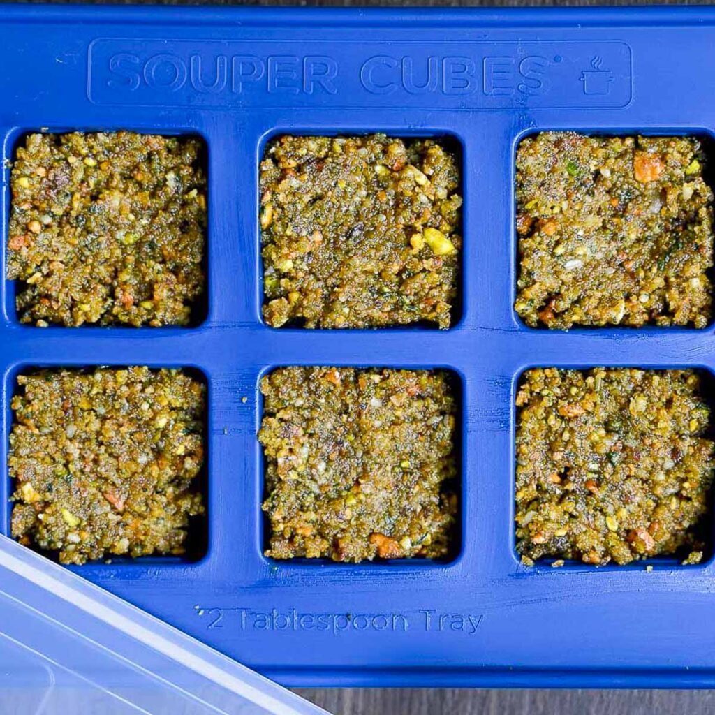 Pistachio basil pesto in individual servings, ready to be frozen.