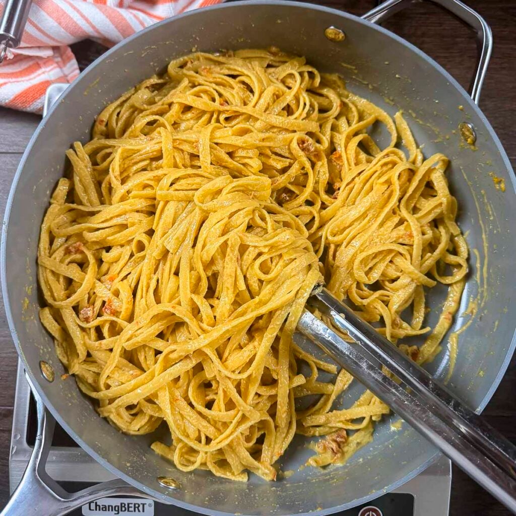Creamy vegan pasta sauce that has been tossed with fettuccini noodles.