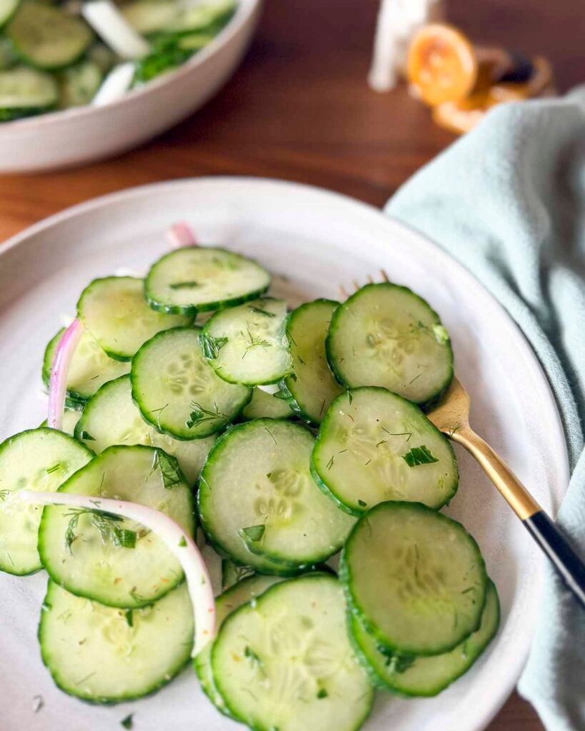 A place filled with cucumber an dill salad.