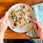 A plate with a couscous salad filed with Mediterranean ingredients.