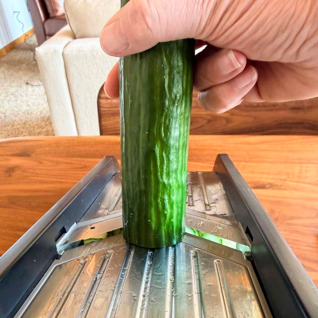 Slicing a cucumber on a mandoline
