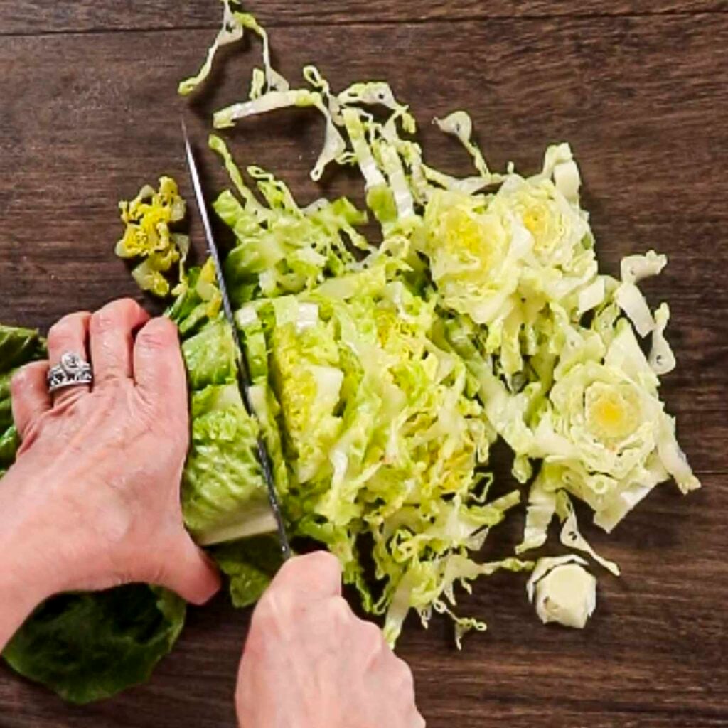 Thinly slicing romaine lettuce as part of making Adding finely chopped fresh dill to maroulosalata.