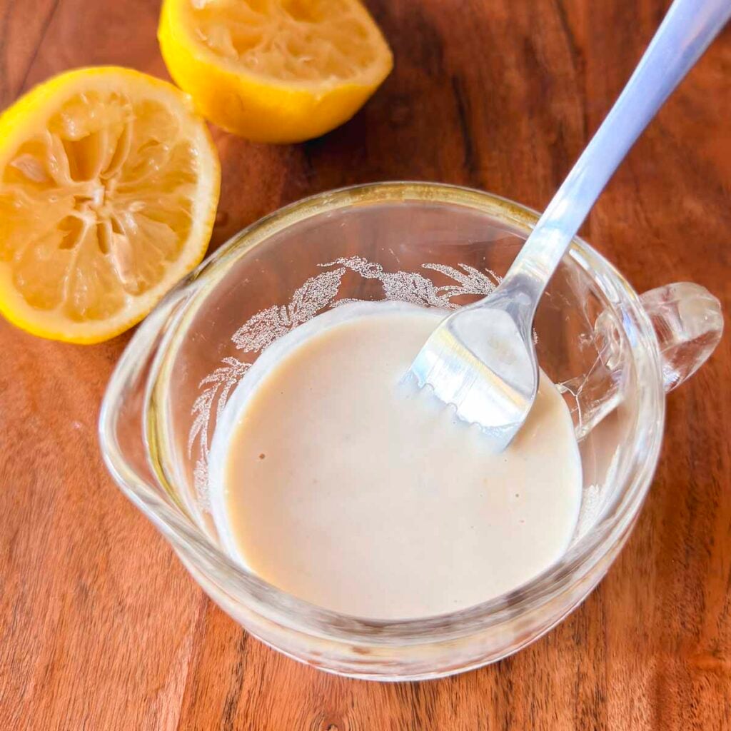 Whisked tahini, lemon juice, and garlic for kale salad dressing.