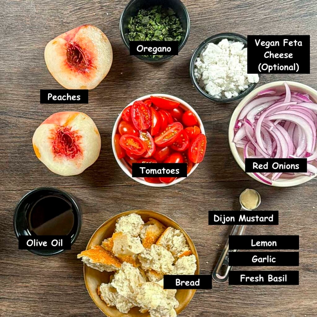 Ingredients for grilled peach panzanella: peaches, grape tomatoes, red onion, rustic bread, oregano, olive oil, lemon, garlic, basil, and optional vegan feta.