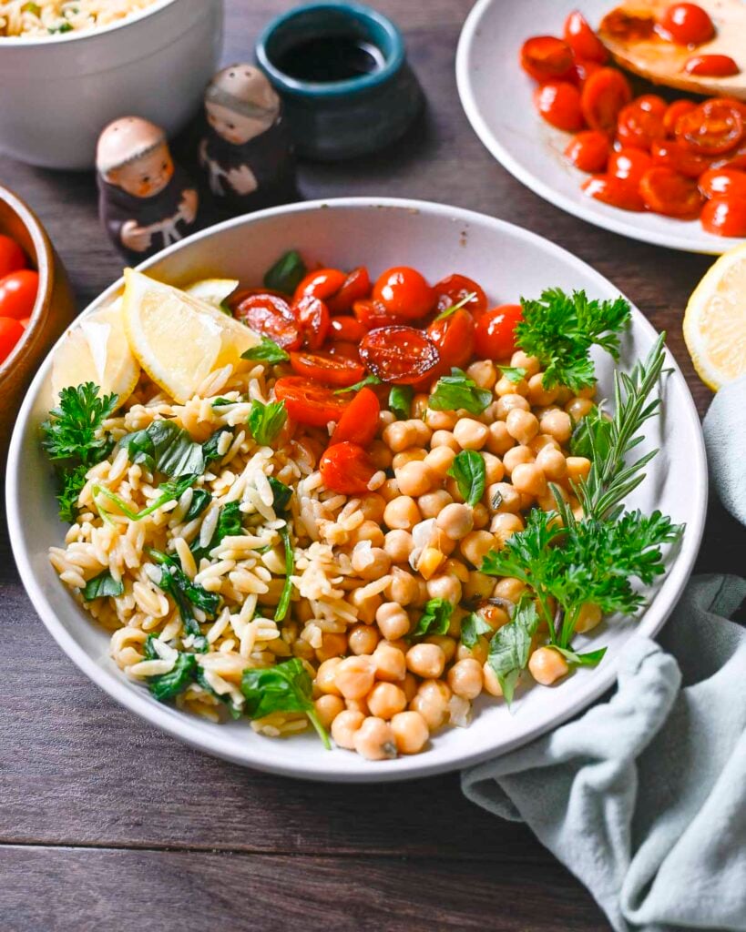 Rosemary-chickpeas, spinach orzo, and blistered tomatoes in a bowl.