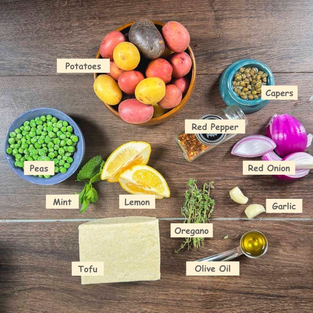 Ingredients for this recipe: tofu, potatoes, peas, mint, lemon, red pepper (optional), capers, red onion, garlic, olive oil, and oregano.